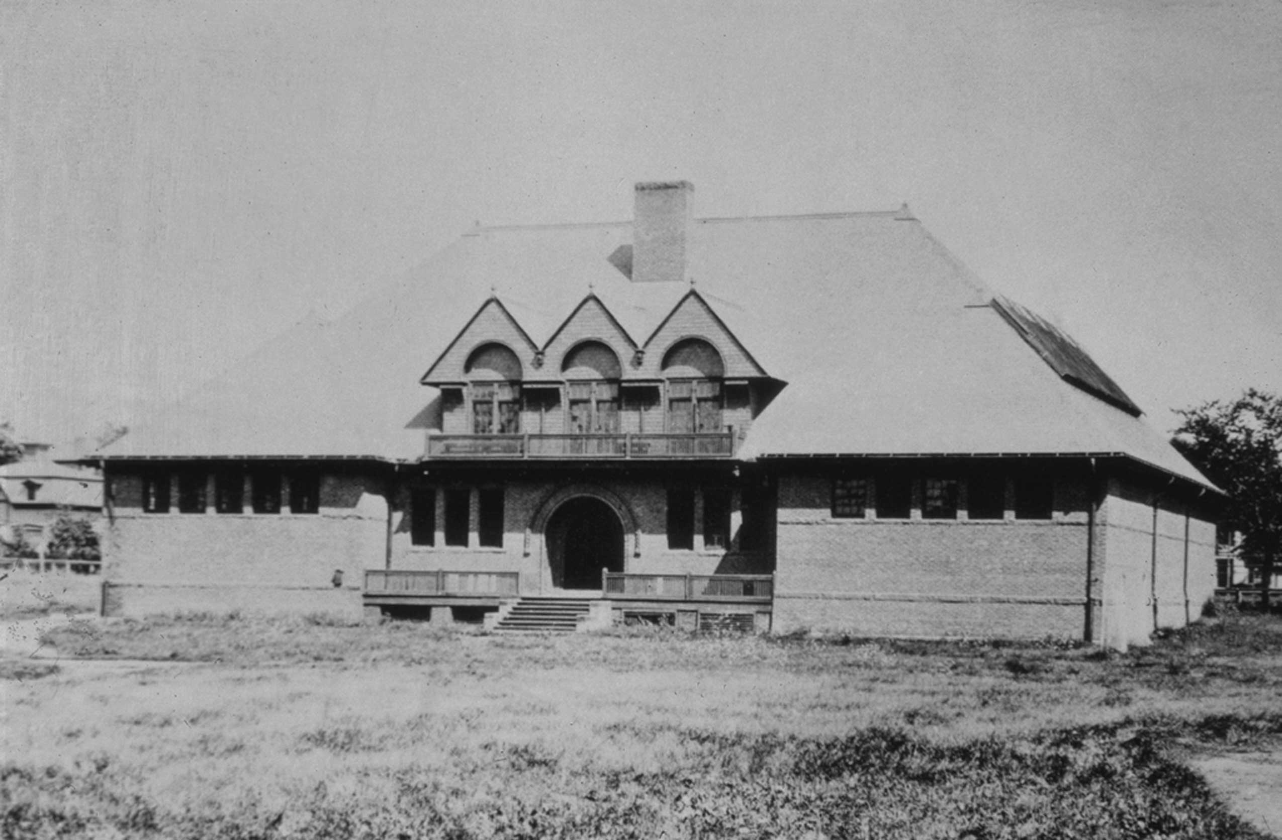 A large brick building with arched entrance.