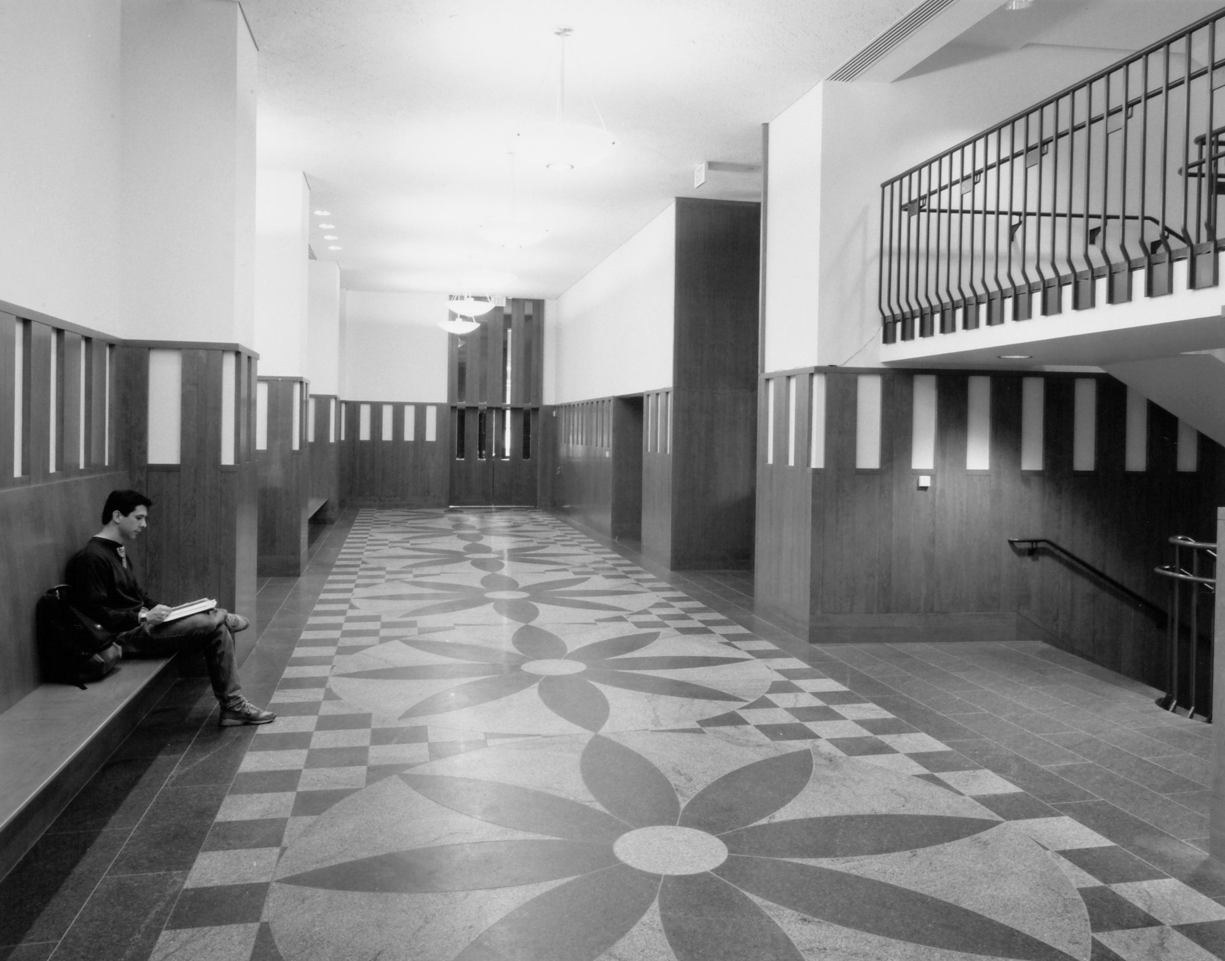 The interior foyer of Hauser features a marble floor with a floral pattern that can also be found on the exterior of Austin Hall.
