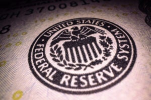 Federal Reserve System stamp on a $100 bill.