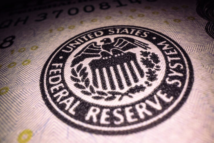 Federal Reserve System stamp on a $100 bill.