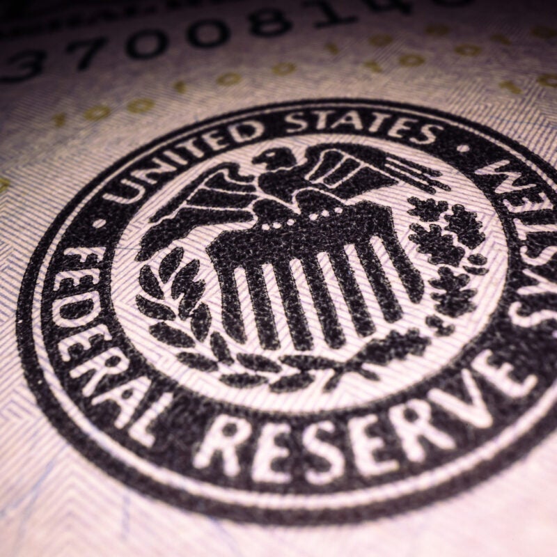 Federal Reserve System stamp on a $100 bill.
