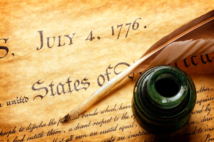 Quill and inkwell on top of Declaration of Independence.