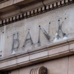 The remains of a sign over a former bank branch.
