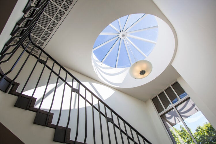 A view to the skylight at the top of a spiral staircase.