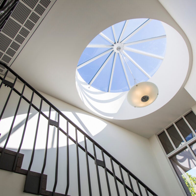 A view to the skylight at the top of a spiral staircase.