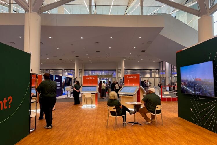 The Thomson West/Westlaw exhibit at AALL with demonstration kiosks, display screens, and booths labeled “Law Firm” and “Academic.”