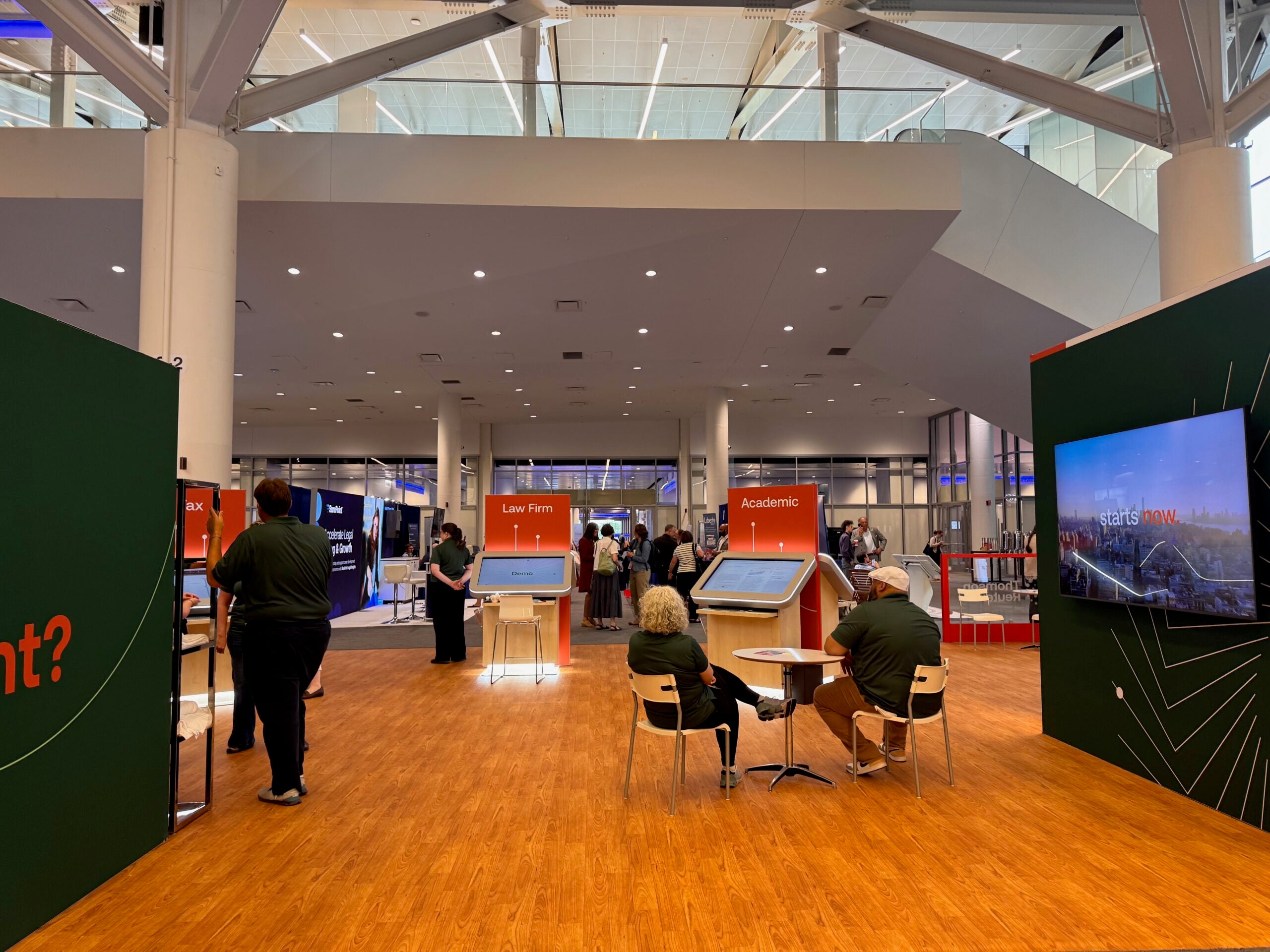 The Thomson West/Westlaw exhibit at AALL with demonstration kiosks, display screens, and booths labeled “Law Firm” and “Academic.”