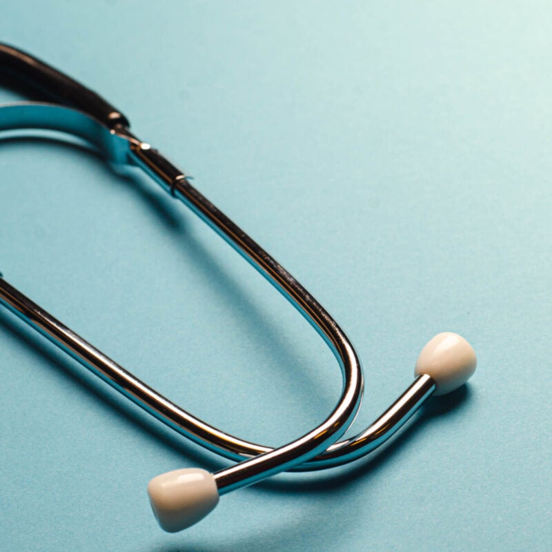 Image of a Stethoscope for diagnosis health medical equipment on light blue background