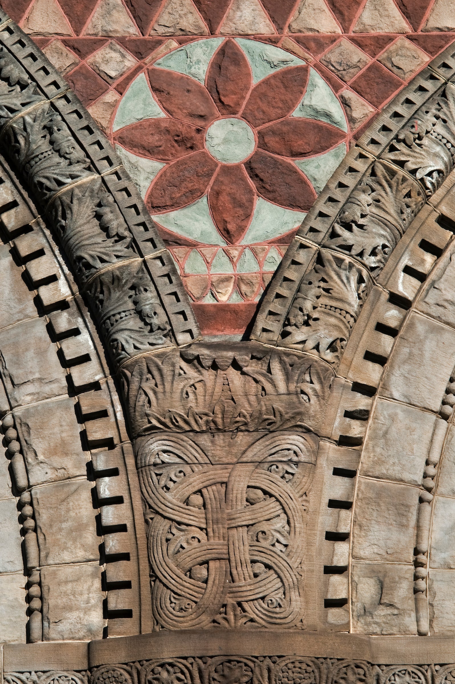 A stone floral detail on the exterior of a building.