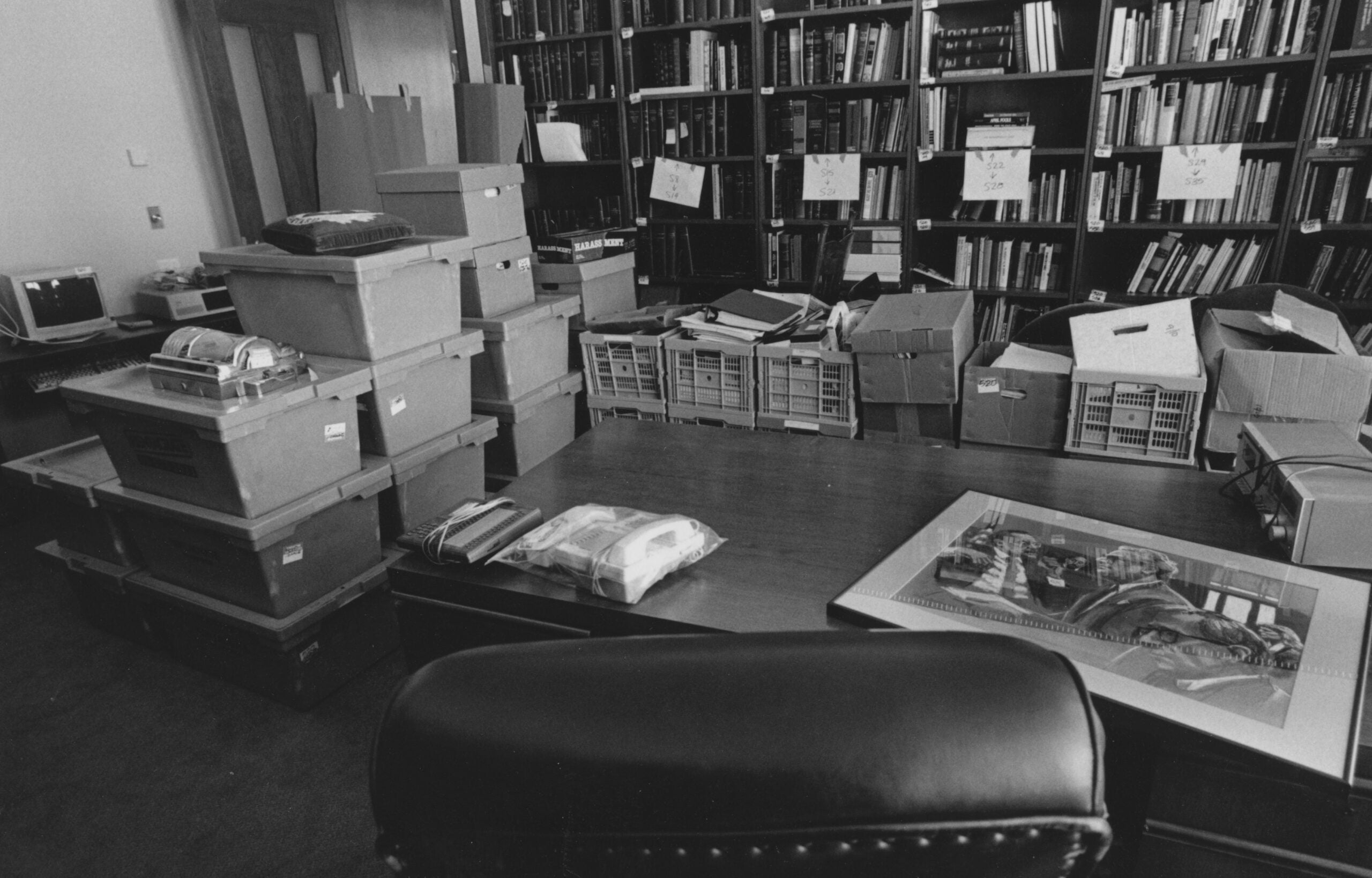 An office filled with unpacked boxes.