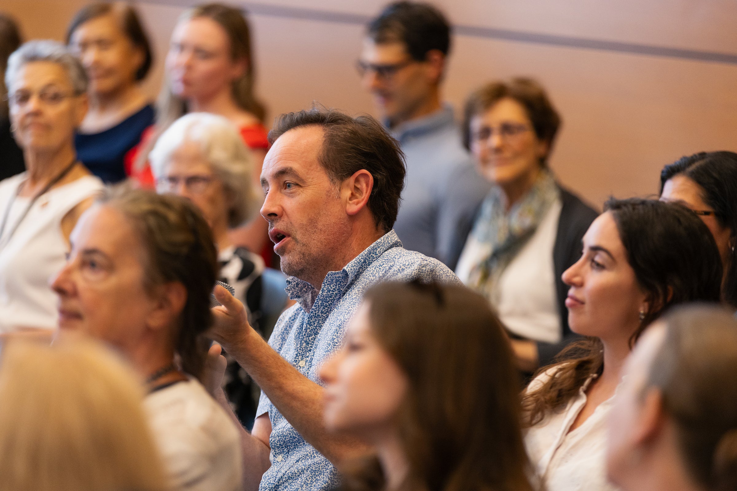 An audience member asks a question.