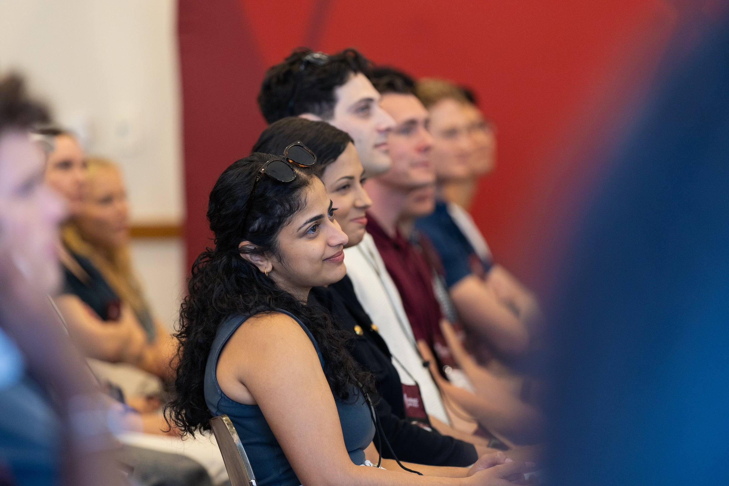 Students sitting in an audience listen intently to a speaker.