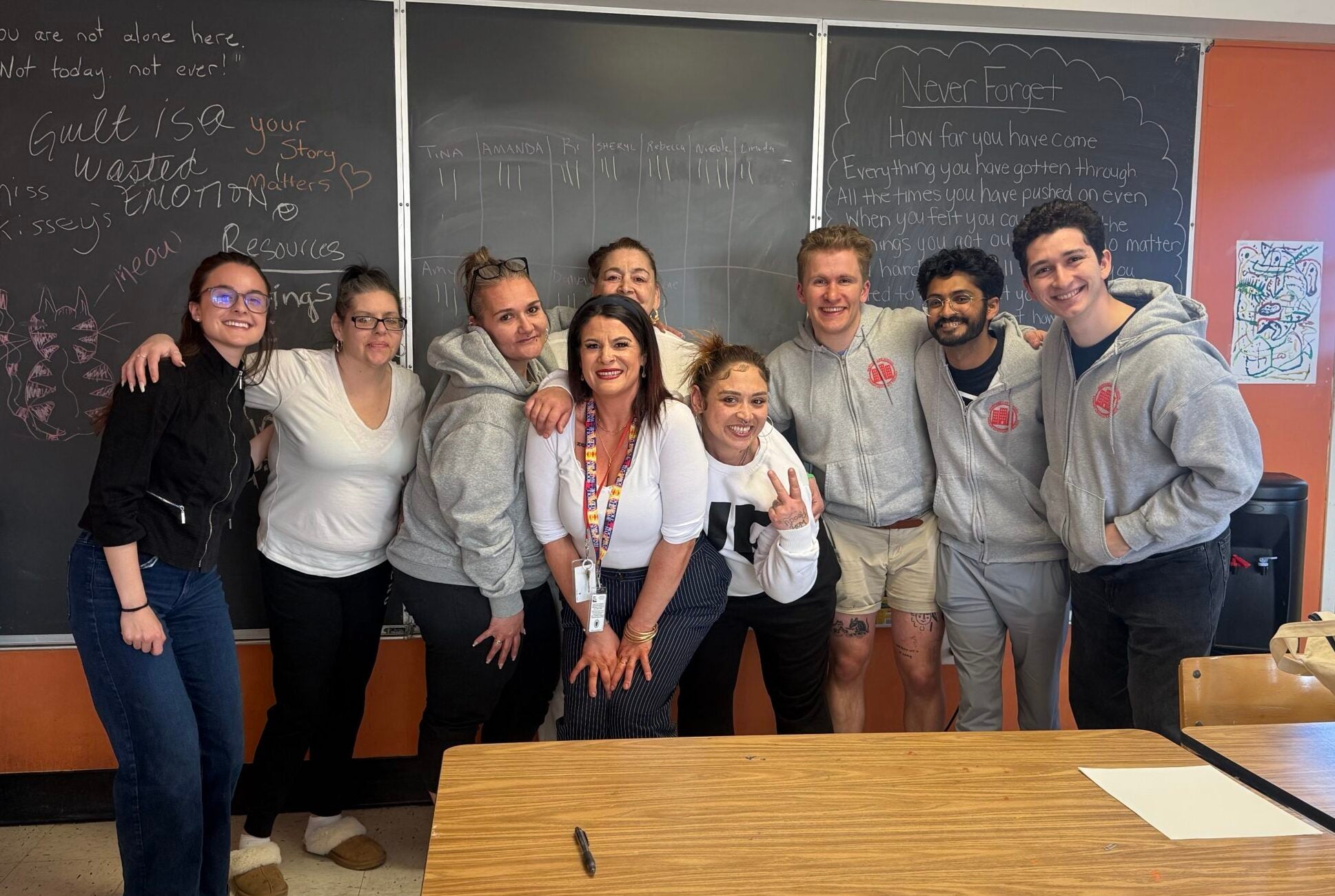 a group of students standing in a classroom