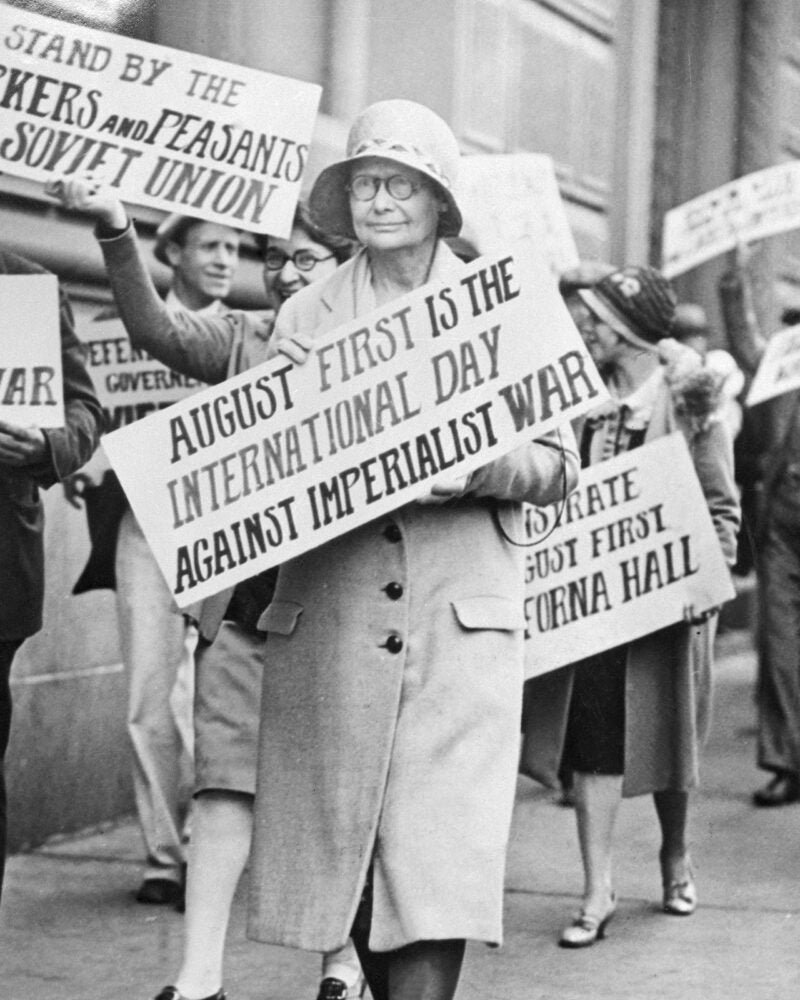 Anita Whitney carrying placard in front of the Chinese Consulate.