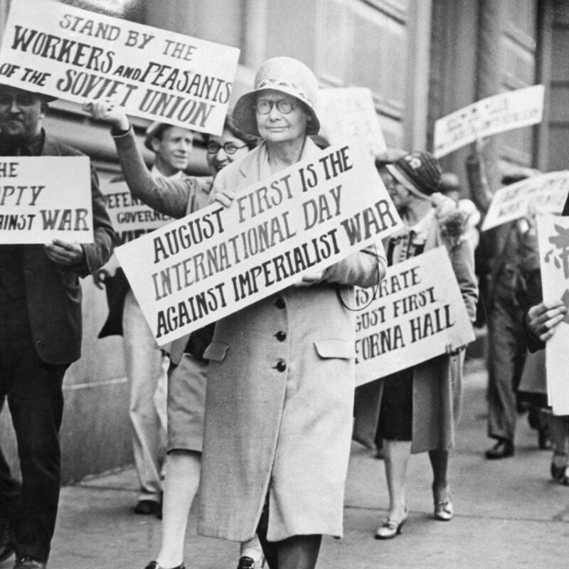 Anita Whitney carrying placard in front of the Chinese Consulate.