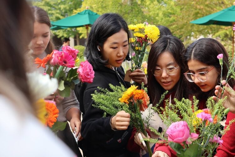 A group of students creating bouquets