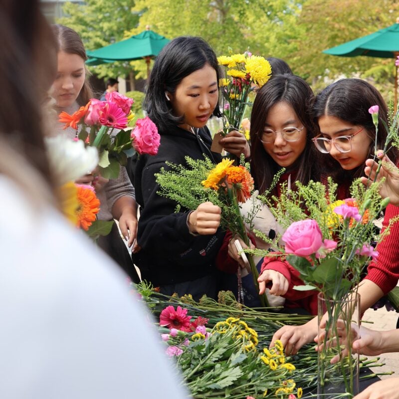 A group of students creating bouquets