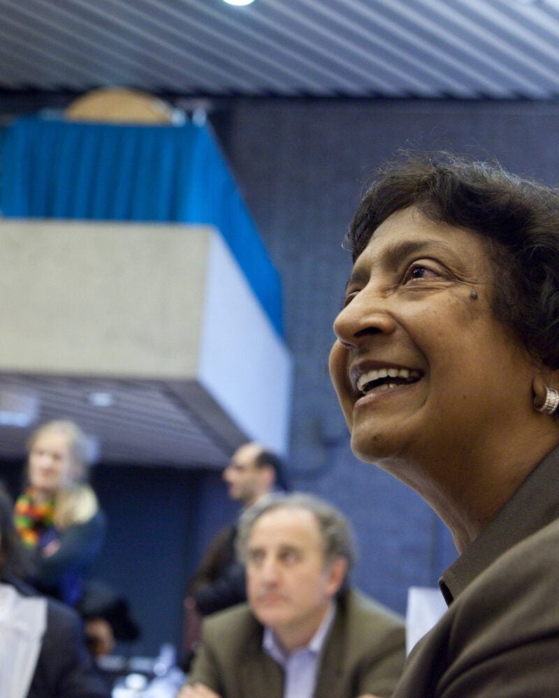 Navi Pillay smiles while engaging in conversation.