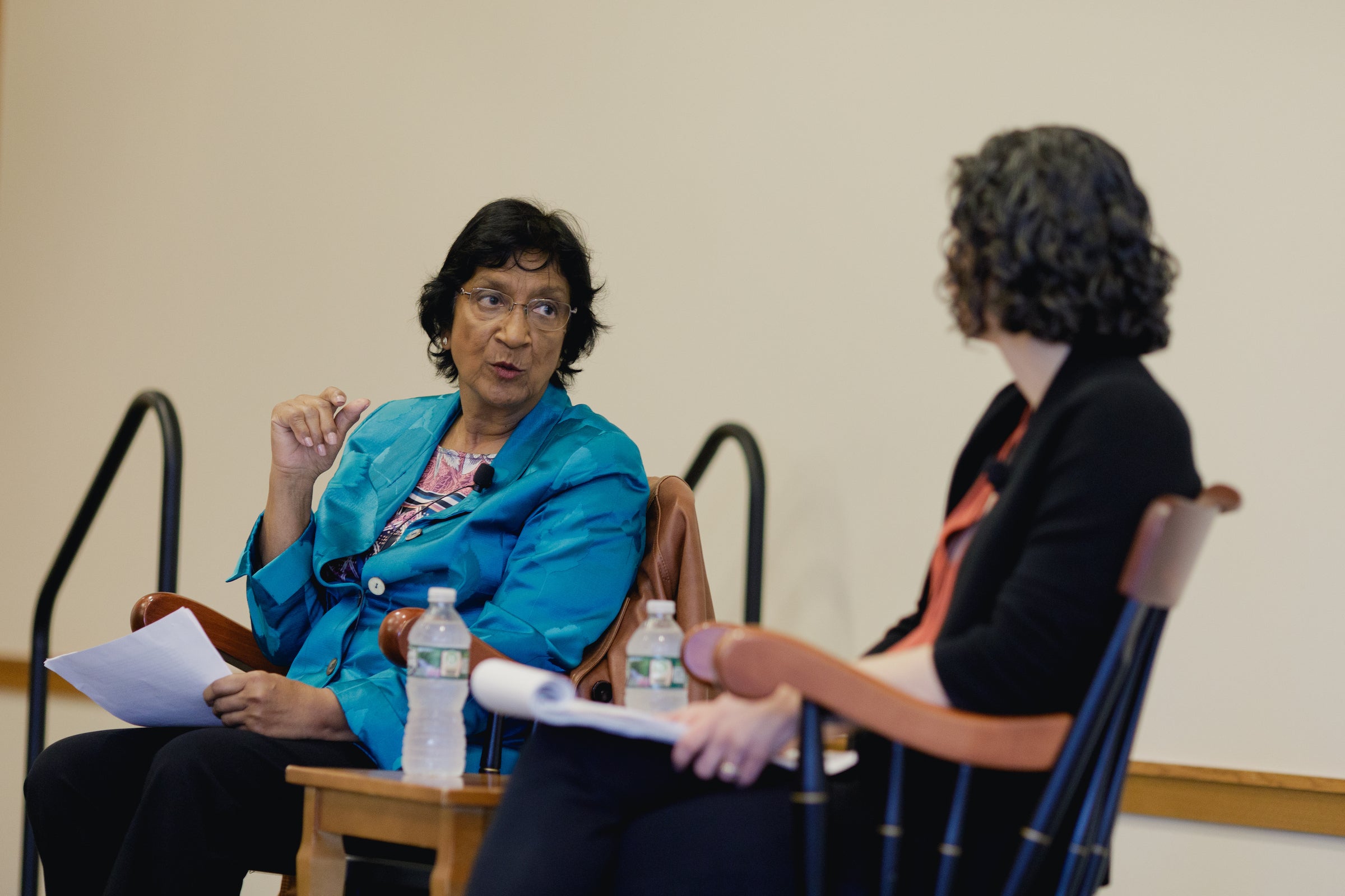 Navi Pillay speaks with Susan Farbstein while seated on a stage.