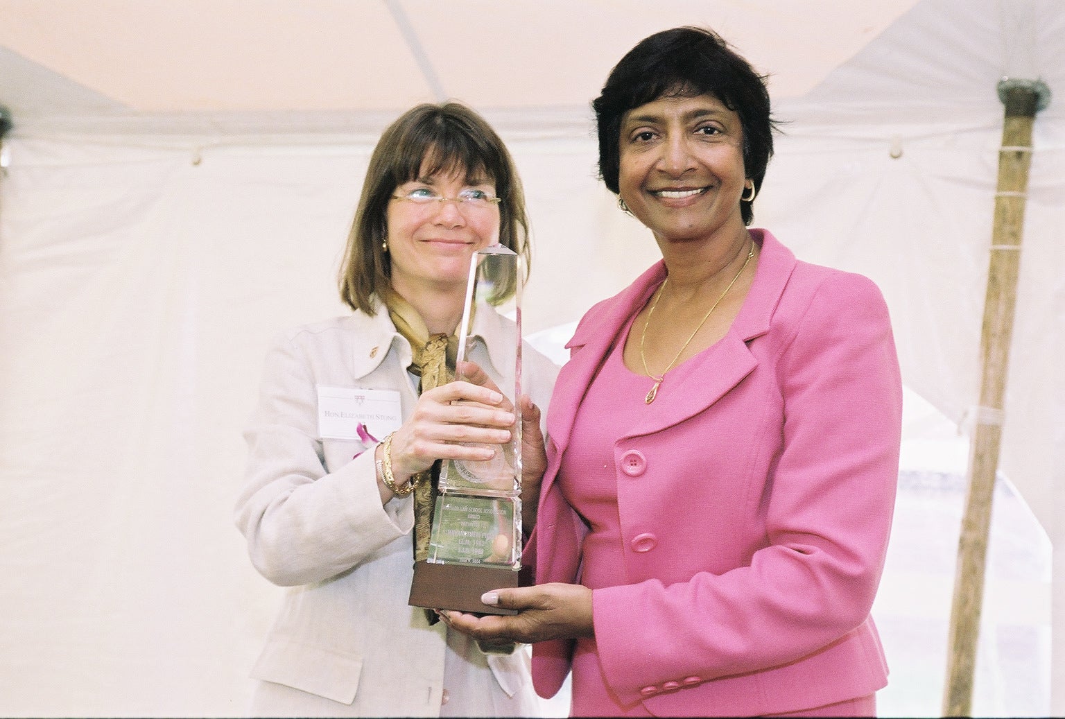 Navi Pillay smiles at the camera while holding an award.