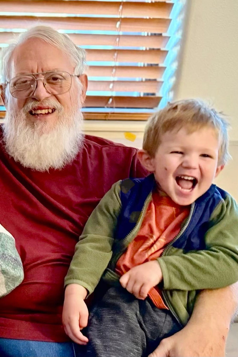 Frank Andrews sitting down with a kid lauging