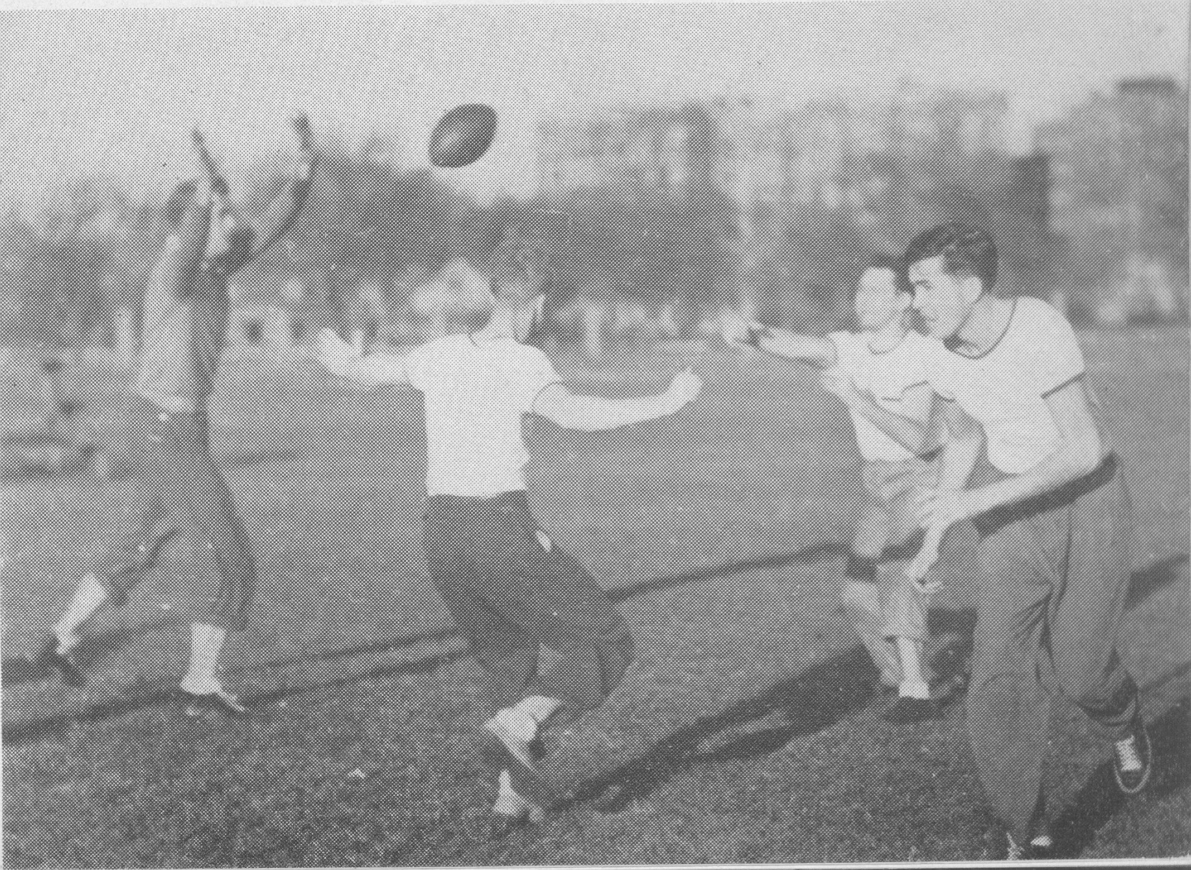 1938 photo of men playing football on a field.