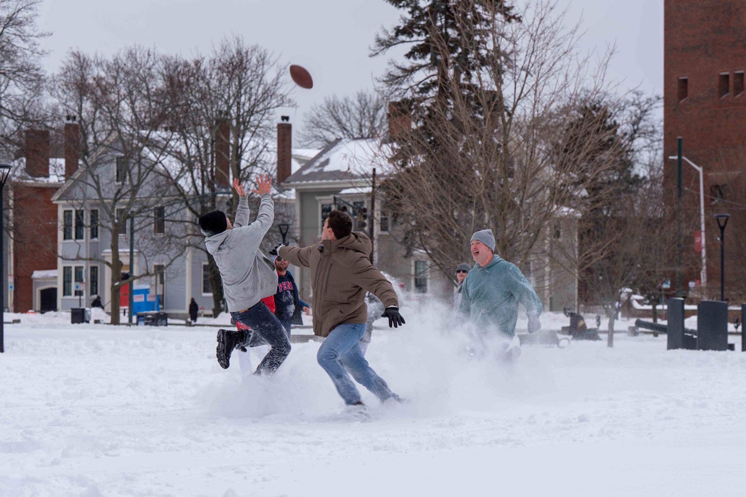 Harvard Law School students play flag football during a snow day