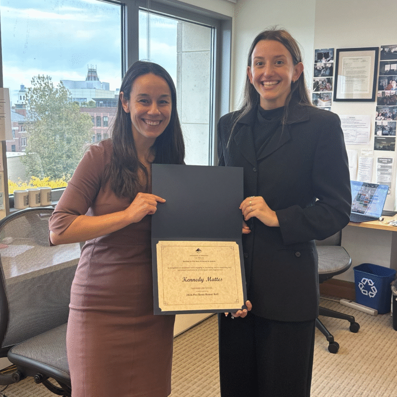 Merry Boak and Kennedy Mattes stand in PLAP holding the AALS certificate
