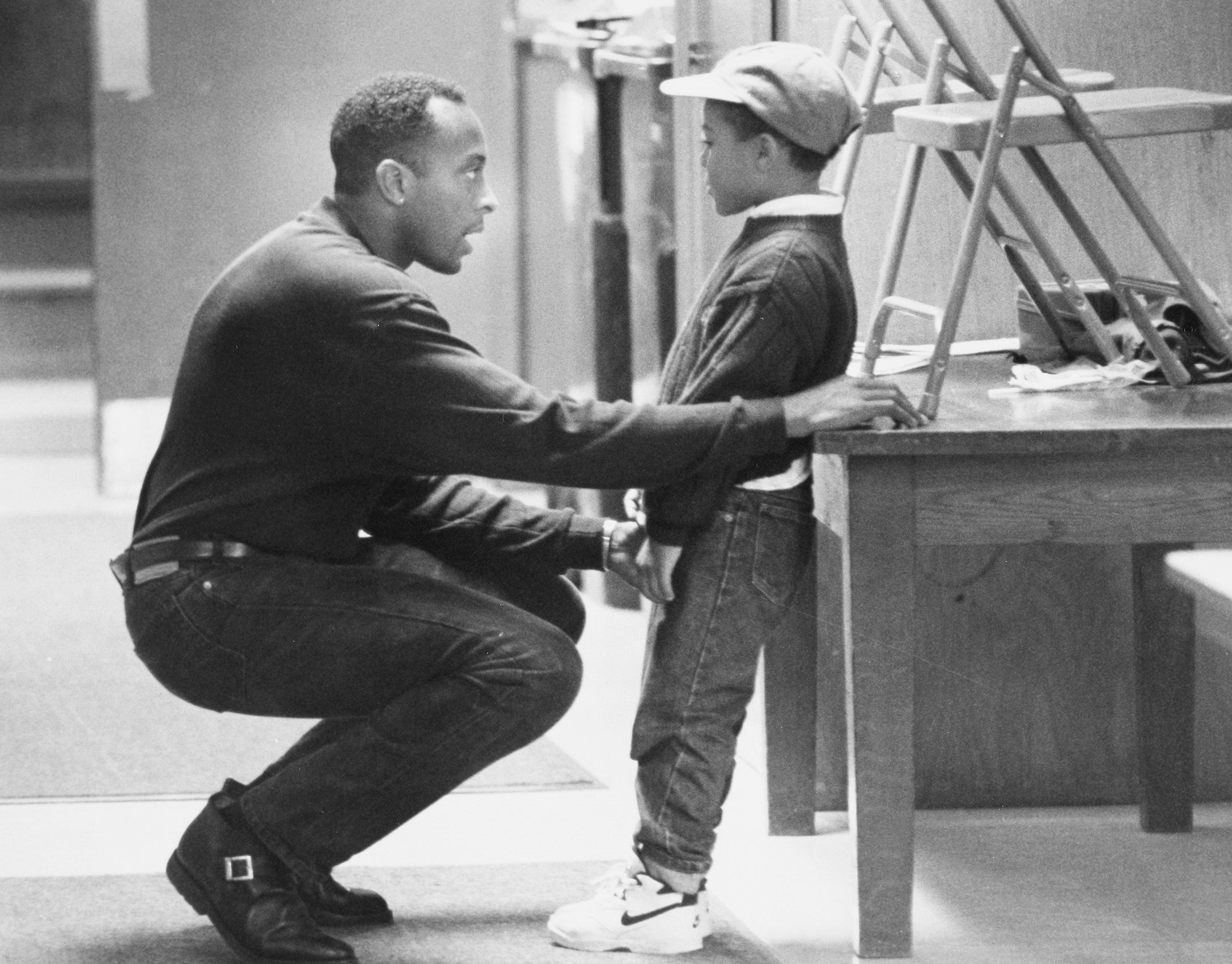 Earl Phalen talking with a young boy.