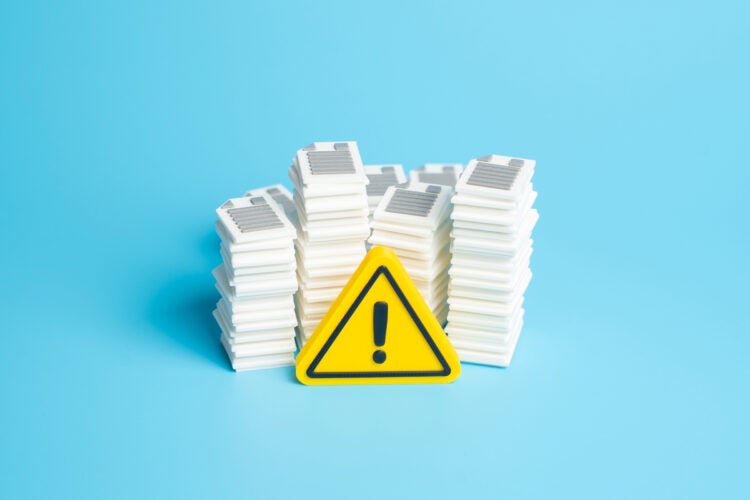 Warning sign in front of a pile of documents.