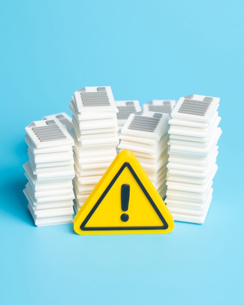 Warning sign in front of a pile of documents.